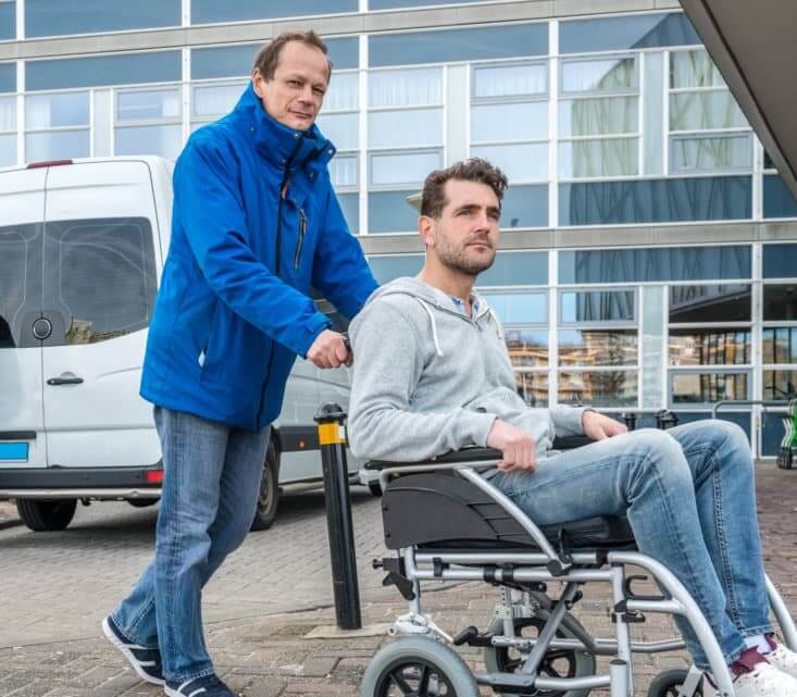 Man Pushing Son On Wheelchair