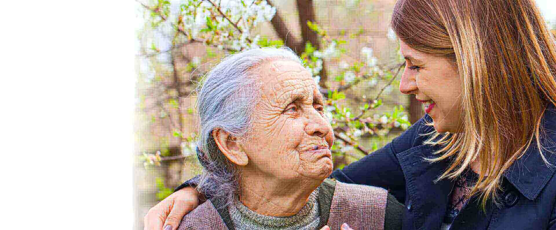 Picture of an elderly woman with cheerful caregiver