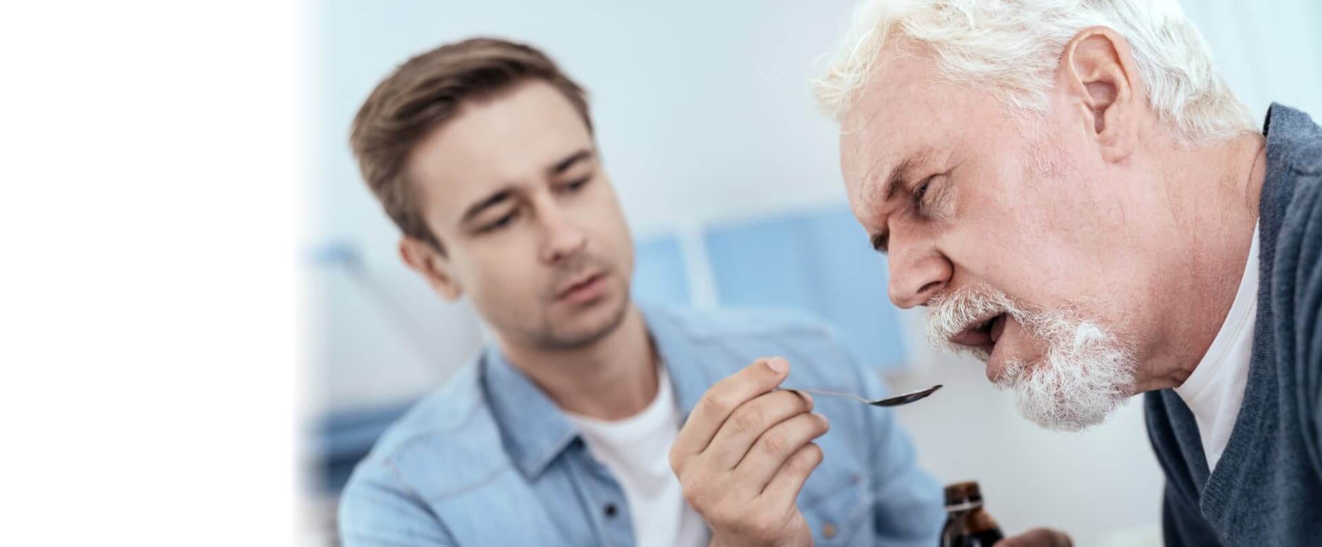 Man using spoon while exhausted senior man taking drug
